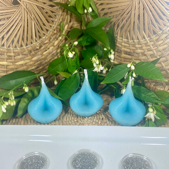 Three blue Destiny Decision Candles, each on its own black iron holder. The slideshow follows the Trio Set burn as the dual flames melt the teardrop-shaped candles, revealing a Yes or No coin in each final pool of wax.
